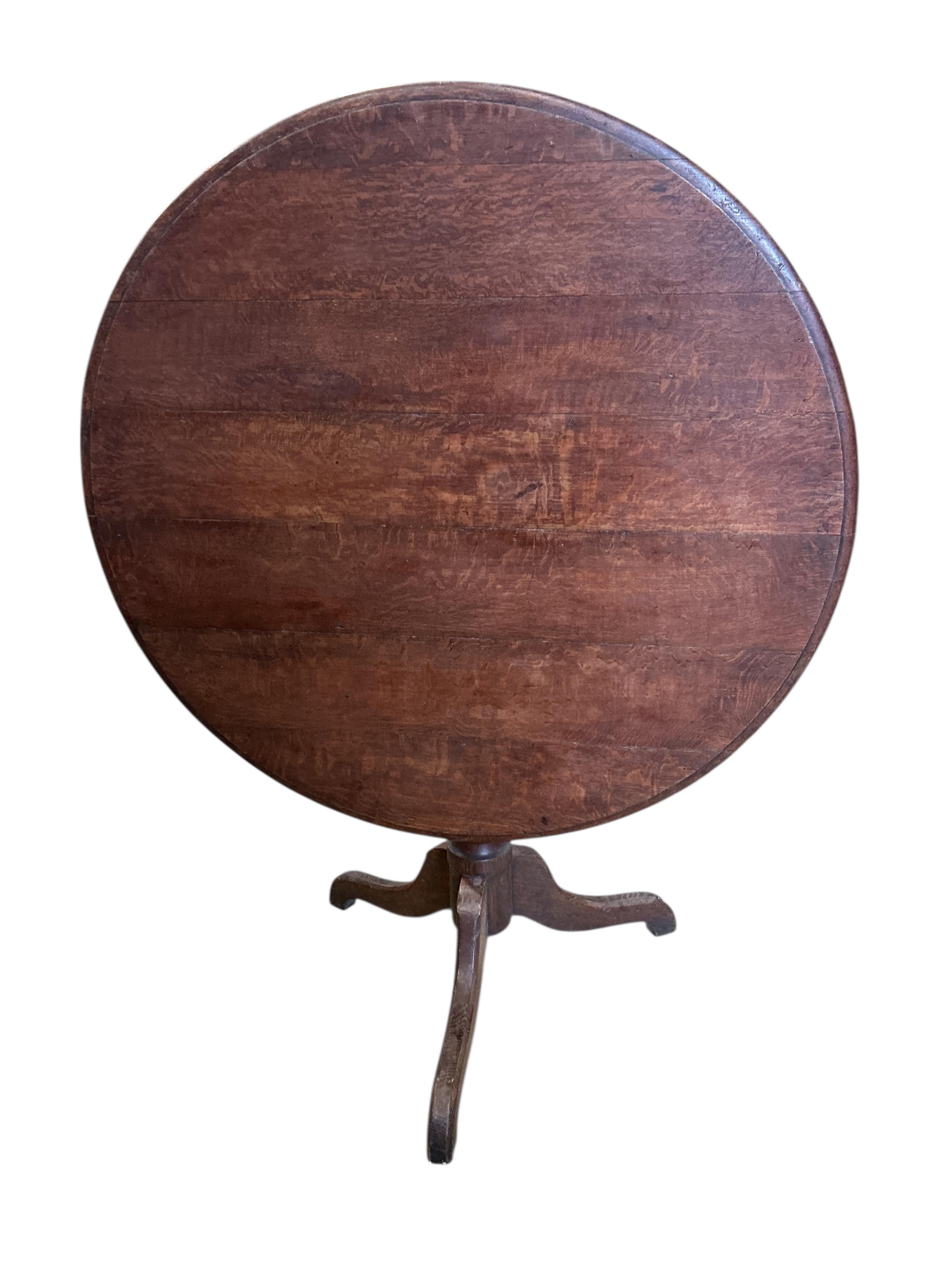 A 19th century circular oak tilt top tripod breakfast table, diameter 97cm, height 74cm
